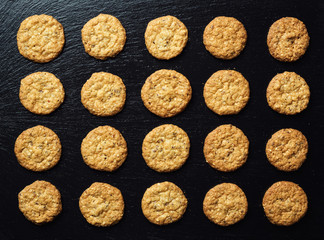 Biscuit sweet cookie background. Domestic stacked butter biscuit pattern concept,close up macro.Homemade cookies on wooden table.Cereal biscuits with the sesame,peanuts,sunflower and amaranth.