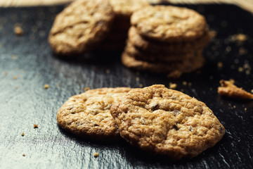 Biscuit sweet cookie background. Domestic stacked butter biscuit pattern concept,close up macro.Homemade cookies on wooden table.Cereal biscuits with the sesame,peanuts,sunflower and amaranth.