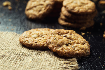 Biscuit sweet cookie background. Domestic stacked butter biscuit pattern concept,close up macro.Homemade cookies on wooden table.Cereal biscuits with the sesame,peanuts,sunflower and amaranth.