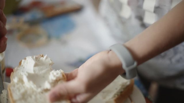 Female hands making a sandwich. Putting cheese on bread. Close-up.