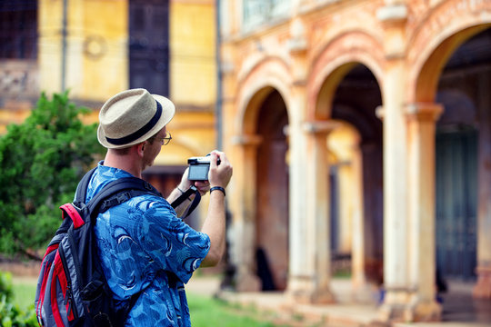 Young traveller men taking pictures of ancient city in French style