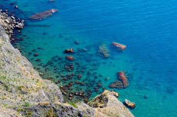 Fototapeta na wymiar Blue azure seaside with corals sand and stones