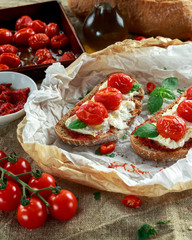 Tomato Ricotta Bruschetta with sun dried tomatoes paste, olive oil brown bread and basil