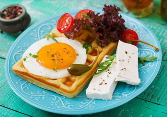 Healthy breakfast - waffles, eggs, feta cheese, tomatoes and lettuce