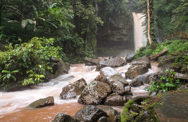 Scenic view of waterfall in the jungle. Long exposure shot. Smooth water jets falling down on stones. Mahua waterfall, Borneo island, Sabah, Malaysia