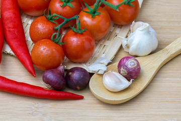 onion garlic and tomato on wooden table. top view