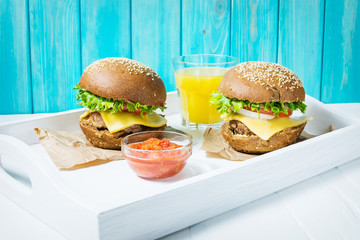 Fresh homemade burgers served on white tray