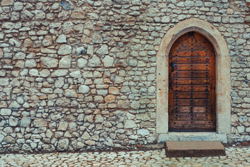 Wooden door in a stone wall