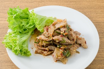 Plate of Spicy Grilled Beef Salad on Wooden Table
