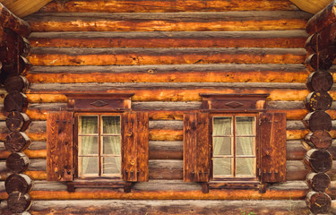 Log cabin wall and windows with shutters in Lake Baikal, Russia