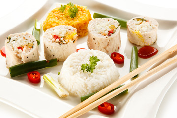 Roast, stuffed chicken  roulade with rice and vegetables on white background 