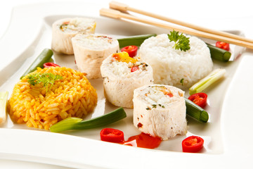 Roast, stuffed chicken  roulade with rice and vegetables on white background 
