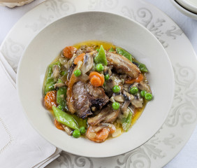 Lamb meat in a sauce with vegetables