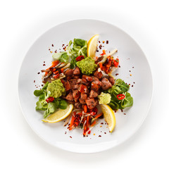 Grilled sausages with vegetables on white background