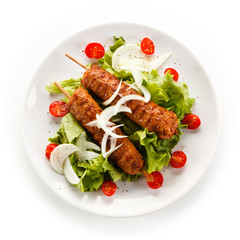 Kebabs - grilled meat and vegetables on white background 