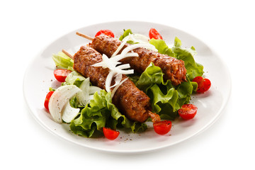 Kebabs - grilled meat and vegetables on white background 