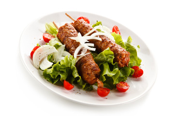 Kebabs - grilled meat and vegetables on white background 