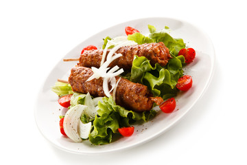 Kebabs - grilled meat and vegetables on white background 