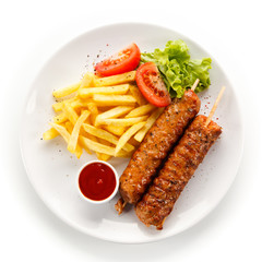 Kebabs - grilled meat and vegetables on white background 