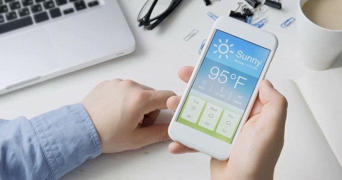 Checking wather using smartphone app. Hot and Sunny weather.