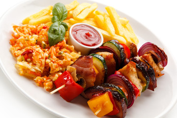 Kebabs - grilled meat and vegetables on white background 