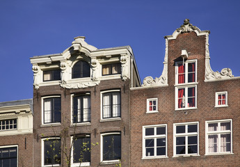 Fototapeta na wymiar Fragment of old houses in Amsterdam. Netherlands