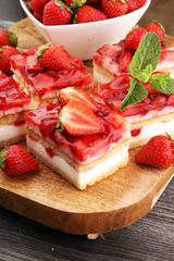 strawberry cake on wooden board with fresh strawberries