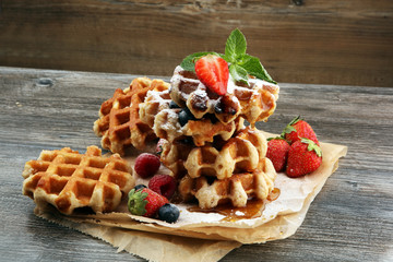 Traditional belgian waffles with fresh fruit and powder sugar