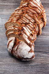 freshly baked bread on wooden board. cutted bread