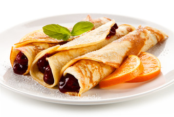 Crepes with cherries and cream on white background 