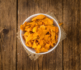 Sweet Potato Chips on wooden background; selective focus