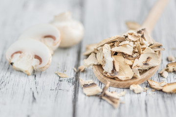 Wooden table with Dried white Mushrooms, selective focus