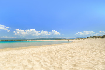 Famous pristine sunny beach Voidokilia in Greece, with beautiful golden beach sand. Summer sunny day skyline scenery. Popular summer resort, travel landmark and vacation destination.
