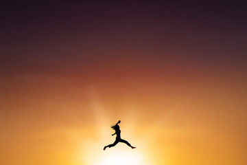 Joyful woman leaps at dusk time