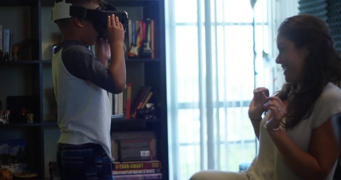 Slow Motion of mother and son playing with a Virtual Reality headset