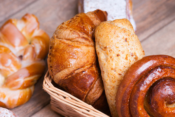 Fresh baked homemade buns and rolls in a wicker basket