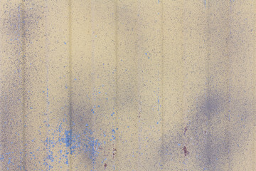 Texture of old sheet metal with worn beige paint