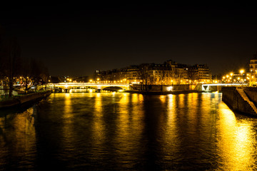 Night urban scene of a calm river crossing a big city