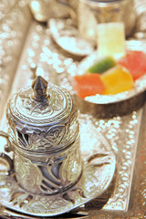 Traditional Turkish coffee with silver metal cup and turkish delight