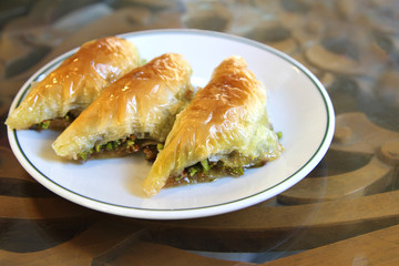 Turkish baklava sobiyet with pistachio nuts.