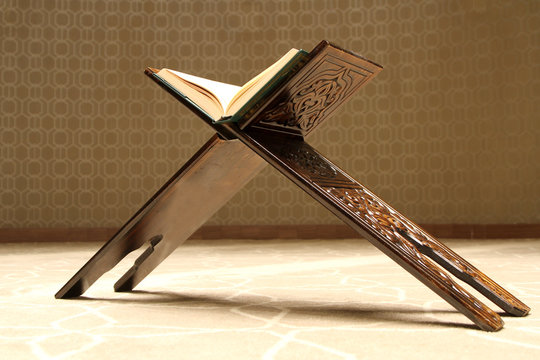 Quran on a wooden stand. Quran is holy book religion of Islam