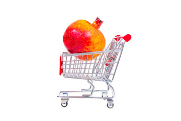 Pomegranate  in shopping cart isolated on white background