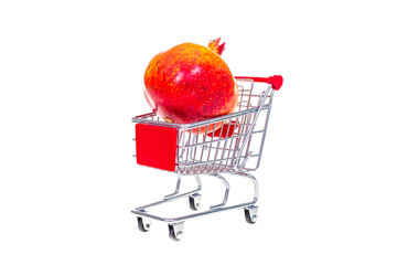 Pomegranate  in shopping cart isolated on white background