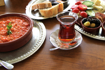  Traditional Turkish breakfast with menemen in a earthenware bowl.