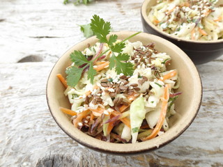 Coleslaw salad with purple carrots and cilantro in a bowl