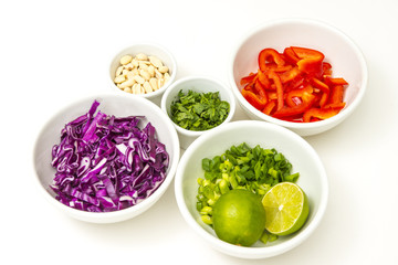 Healthy colorful food chopped produce vegetables recipe ingredients prepared and ready in white bowls background diet lifestyle