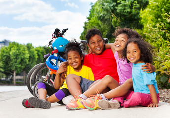 African children sitting on cycle lane in summer