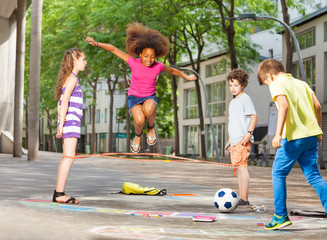 Group of kids play hopscotch on the school