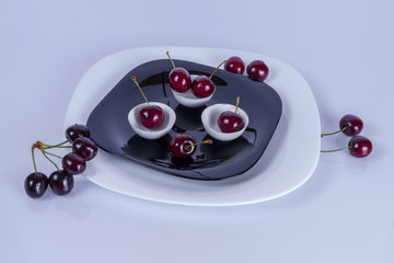 sweet cherry on black plate