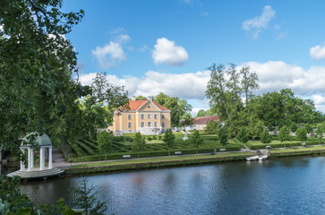 Old building and pavilion on shore of lake. Padise, Estonia